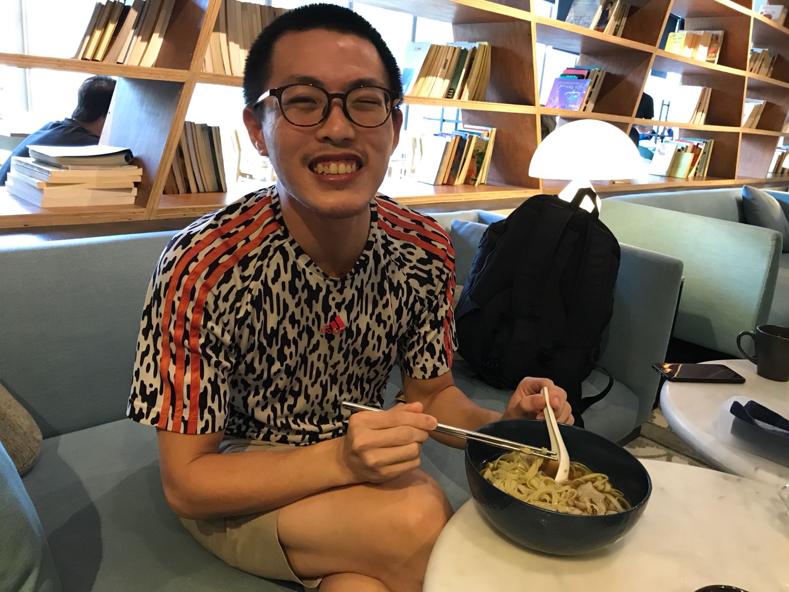 photo of Tony Chen at a meat-free 
                                                restaurant in Singapore, taken in the year 2018 A.D.